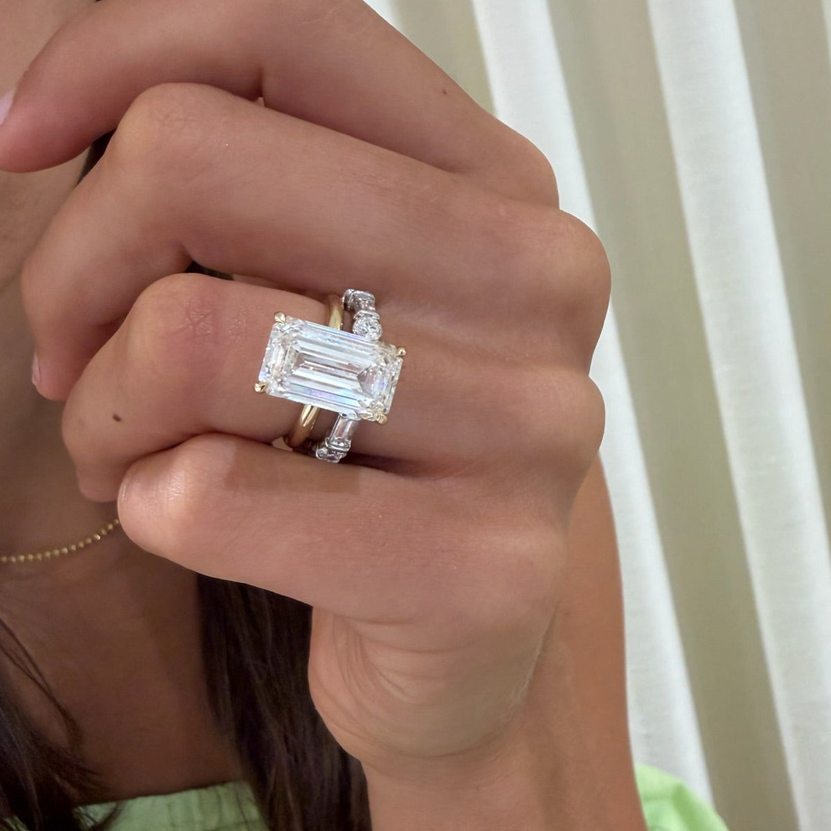 8.06ct Lab Grown Emerald Cut Diamond in a Solitaire Setting with Hidden Halo
and daisy alternating wedding band 