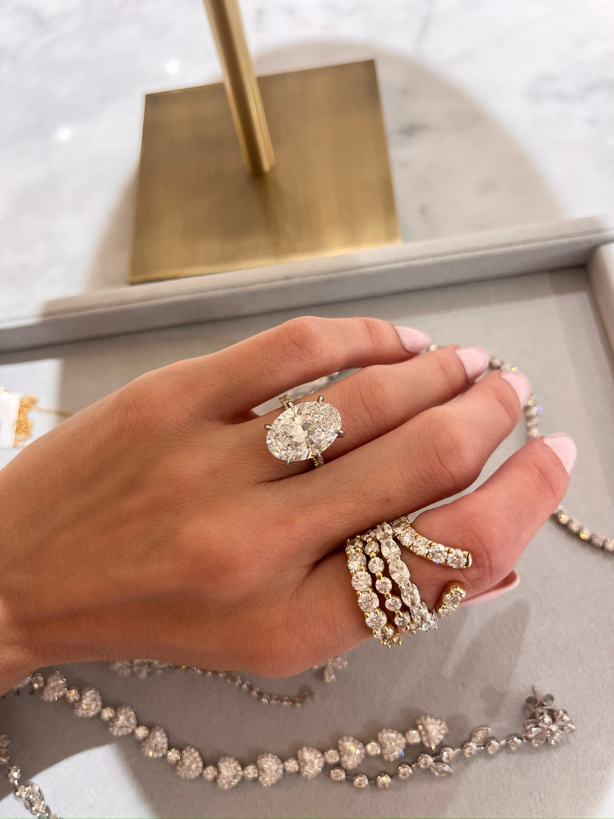 7.14ct Lab Grown Oval Diamond in a Pavé Solitaire with Hidden Halo and Diamonds on the Prongs