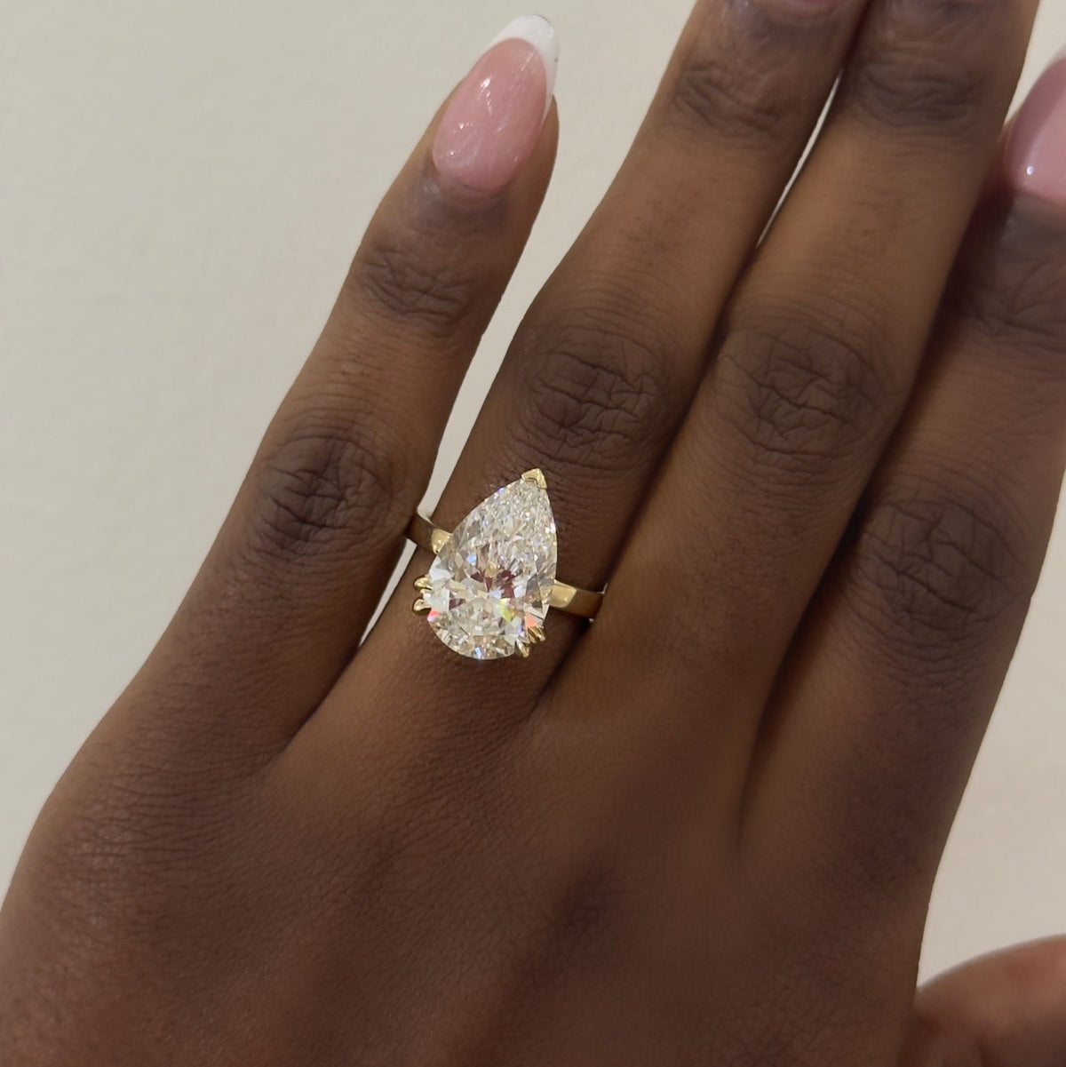 6.07ct Lab Grown Pear Diamond in a 2.5mm Pipe-Cut Solitaire with Hidden Halo