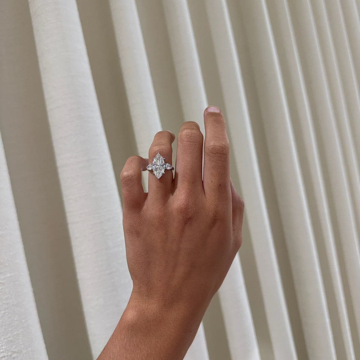 5.09ct Lab Grown Marquise Diamond in a Three-Stone Setting with Pear sides and Diamonds on the Prongs