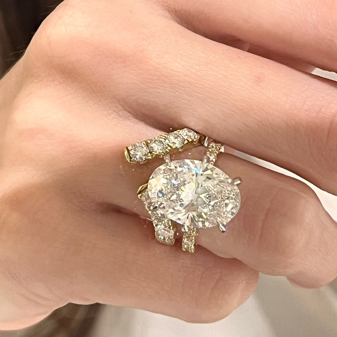 lira with oval diamond engagement ring
