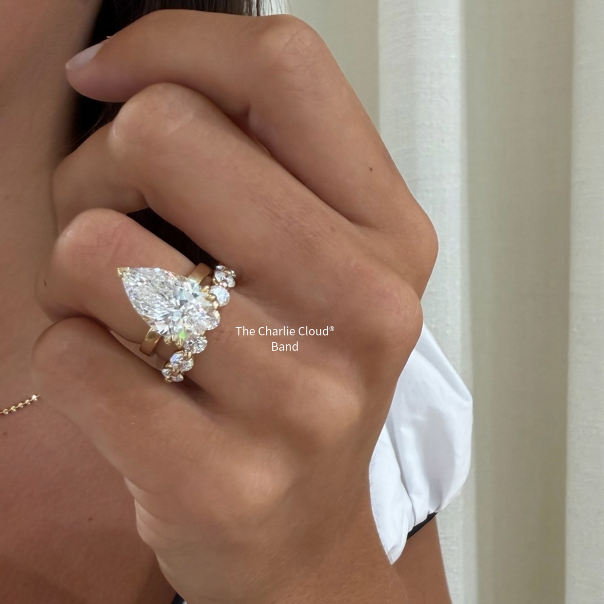 the Charlie Cloud®  YG diamond band with a pear diamond engagement ring 